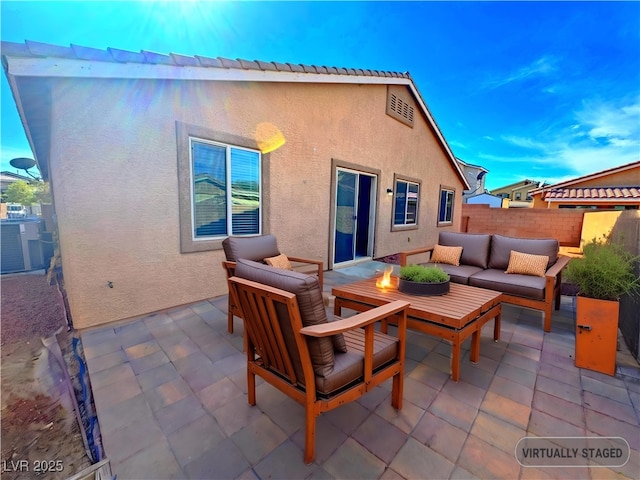 rear view of property featuring a patio area, an outdoor living space, and central AC