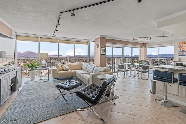 3111 Bel Air Dr Unit 20D, Las Vegas, NV 89109 - living room featuring track lighting, light tile patterned floors, and a textured ceiling