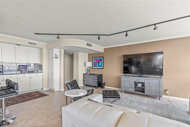 3111 Bel Air Dr Unit 20D, Las Vegas, NV 89109 - living area featuring rail lighting, light tile patterned flooring, and ornamental molding