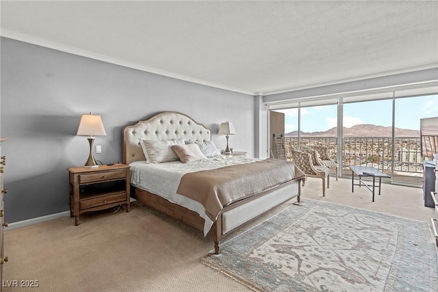 bedroom featuring access to exterior, a mountain view, and carpet