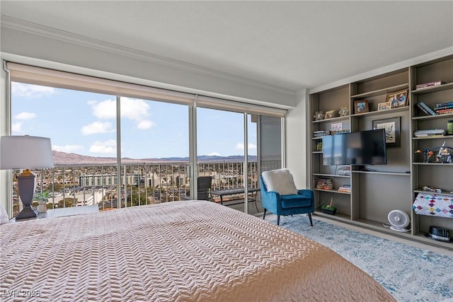 3111 Bel Air Dr Unit 20D, Las Vegas, NV 89109 - bedroom featuring crown molding, a mountain view, and wood finished floors