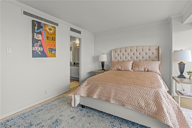 bedroom featuring ornamental molding and ensuite bathroom