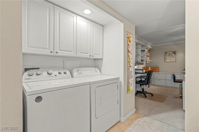 3111 Bel Air Dr Unit 20D, Las Vegas, NV 89109 - laundry room with cabinet space, washer and dryer, light carpet, light tile patterned flooring, and a desk