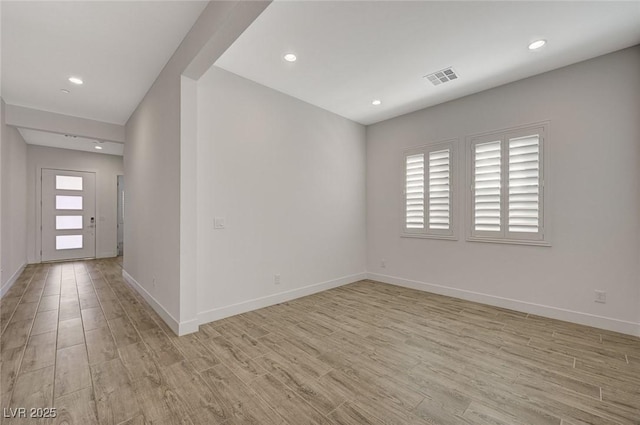 spare room with light hardwood / wood-style flooring