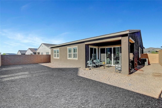 rear view of property with cooling unit and a patio area