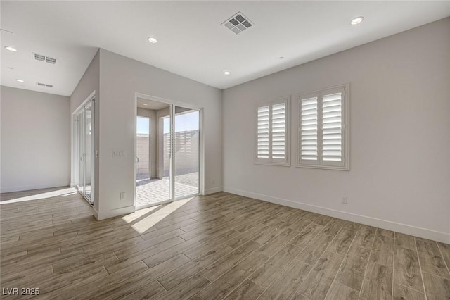 spare room featuring wood-type flooring