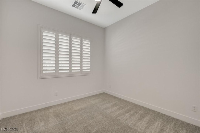 carpeted spare room featuring ceiling fan