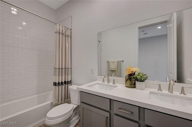 full bathroom featuring vanity, shower / tub combo, and toilet