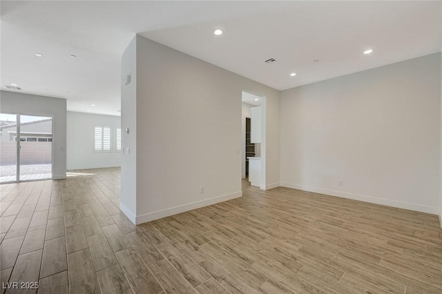 empty room with light hardwood / wood-style flooring