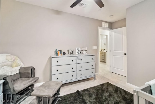 living area with light colored carpet and ceiling fan