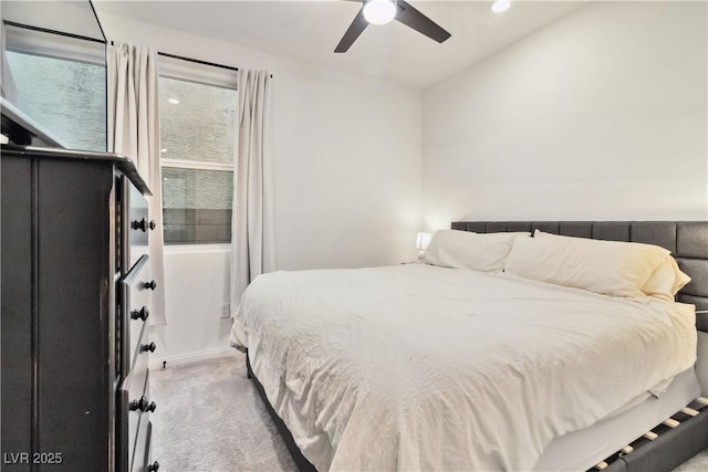 bedroom featuring ceiling fan and light carpet