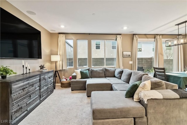 living room with carpet floors and a notable chandelier