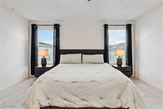 bedroom featuring light carpet and multiple windows