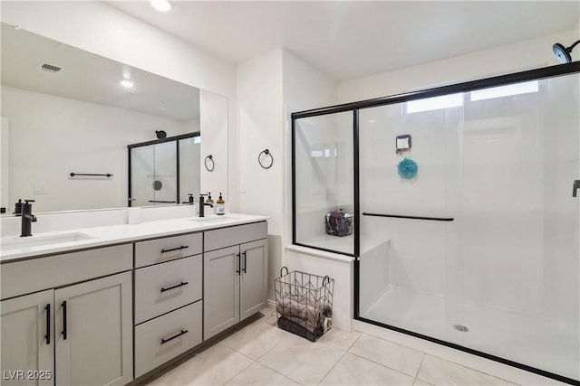 bathroom featuring vanity, an enclosed shower, and tile patterned flooring