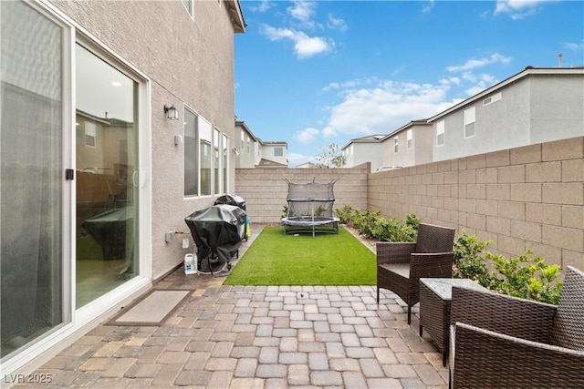 view of patio / terrace with a trampoline and grilling area