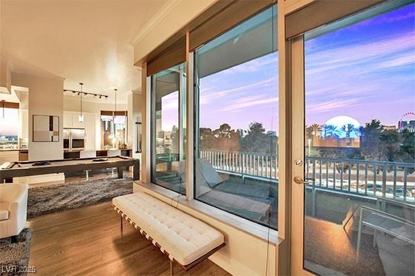 interior space with hardwood / wood-style flooring and crown molding