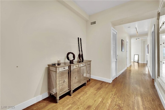 hall with light hardwood / wood-style flooring