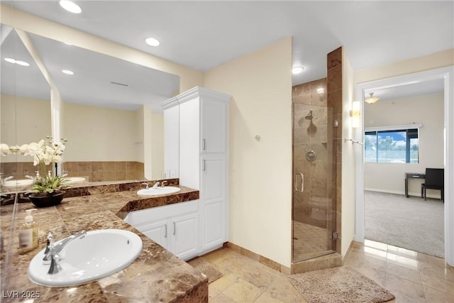 bathroom with vanity and a shower with shower door