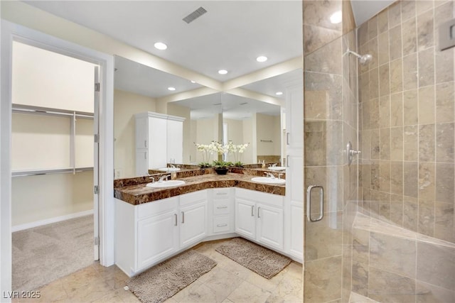 bathroom with walk in shower and vanity