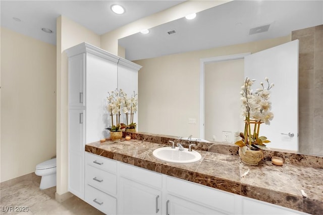 bathroom with vanity and toilet