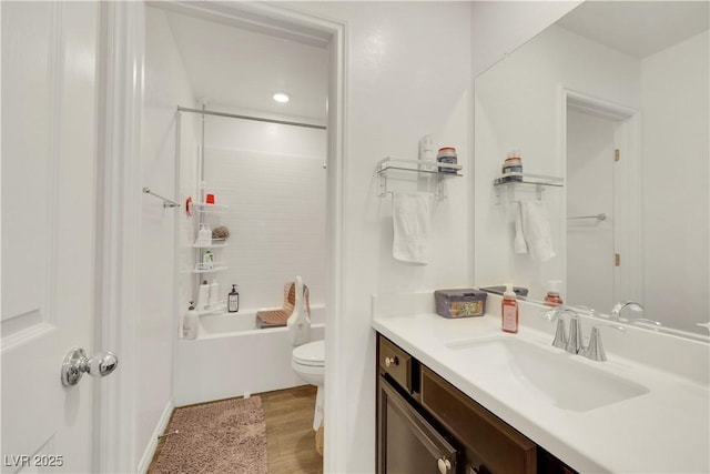 full bathroom featuring vanity, hardwood / wood-style floors, shower / tub combination, and toilet