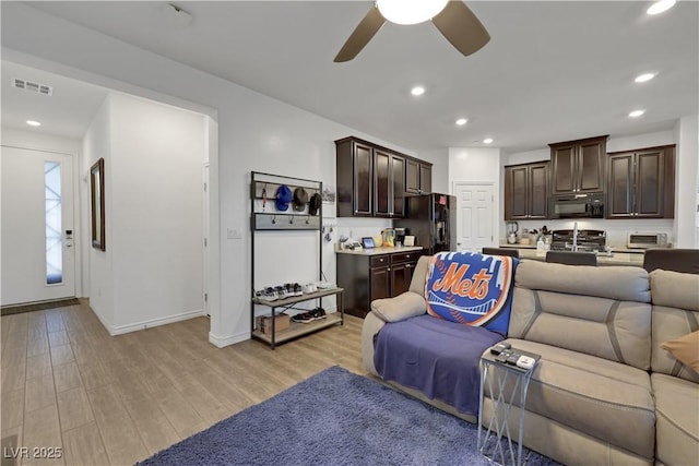 living room featuring ceiling fan and light wood-type flooring