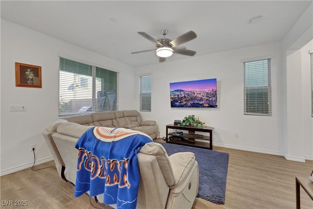 living room with ceiling fan and light wood-type flooring