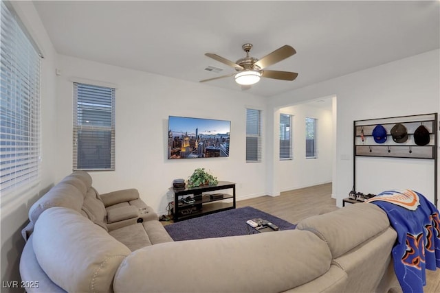 living room featuring light hardwood / wood-style floors and ceiling fan