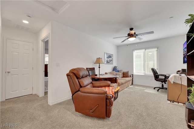 carpeted home office featuring ceiling fan