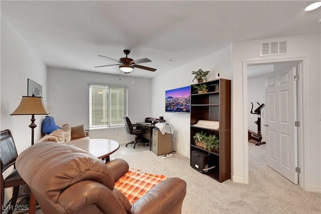 living room with light colored carpet and ceiling fan