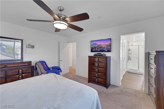 carpeted bedroom with ensuite bathroom and ceiling fan