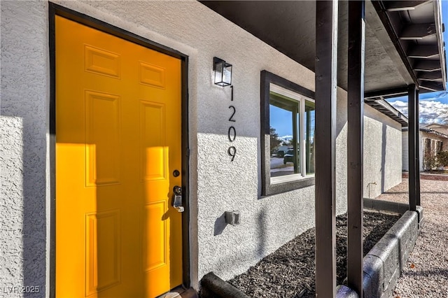 view of exterior entry featuring stucco siding