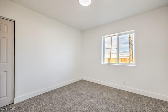 spare room with carpet flooring and baseboards