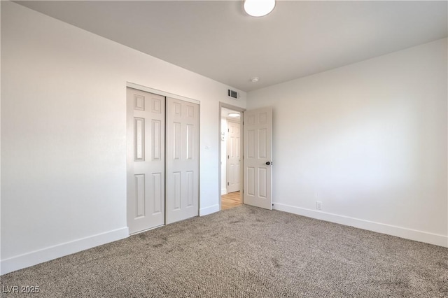 unfurnished bedroom featuring carpet, a closet, and baseboards