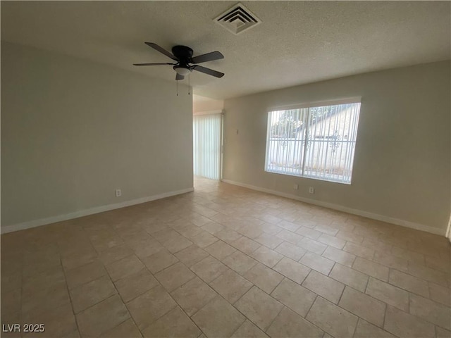 tiled spare room featuring ceiling fan and a textured ceiling