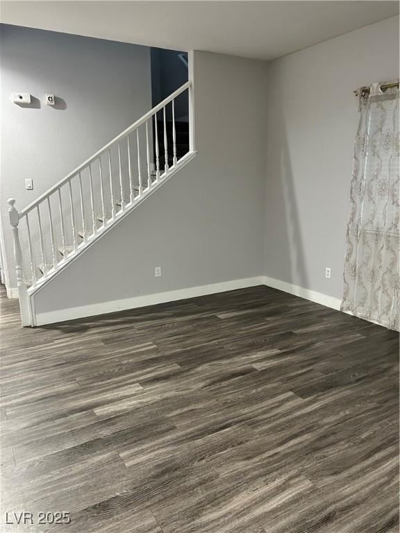 spare room with dark wood-type flooring