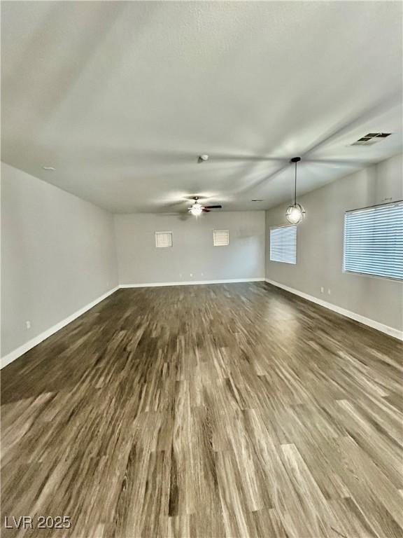 unfurnished room featuring dark hardwood / wood-style floors and ceiling fan