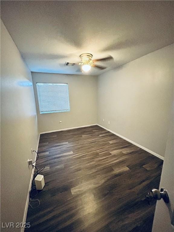 empty room with ceiling fan, dark hardwood / wood-style floors, and a textured ceiling