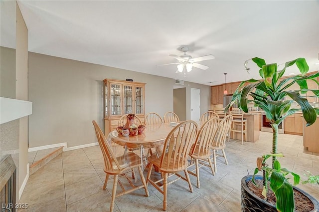 dining area featuring ceiling fan and light tile patterned floors