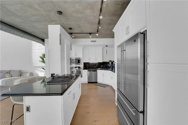 360 E Desert Inn Rd Unit 604, Las Vegas, NV 89109 - kitchen with appliances with stainless steel finishes, dark countertops, a kitchen breakfast bar, white cabinets, and open floor plan