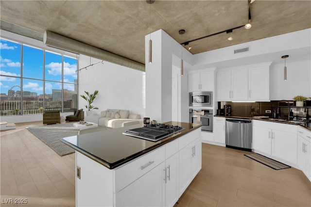 360 E Desert Inn Rd Unit 604, Las Vegas, NV 89109 - kitchen featuring appliances with stainless steel finishes, a sink, dark countertops, and light wood-type flooring