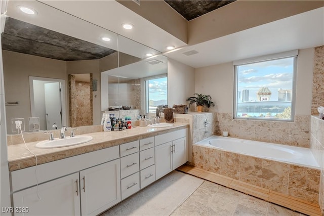 360 E Desert Inn Rd Unit 604, Las Vegas, NV 89109 - full bath featuring double vanity, a garden tub, healthy amount of natural light, and recessed lighting