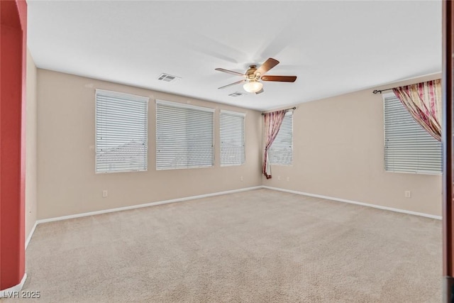 unfurnished room featuring light colored carpet and ceiling fan