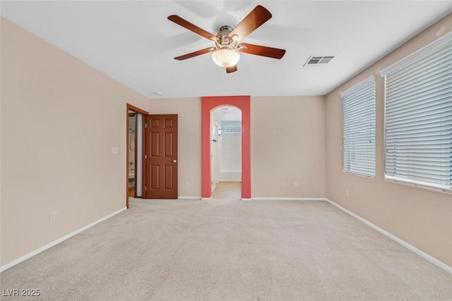 spare room featuring light carpet and ceiling fan