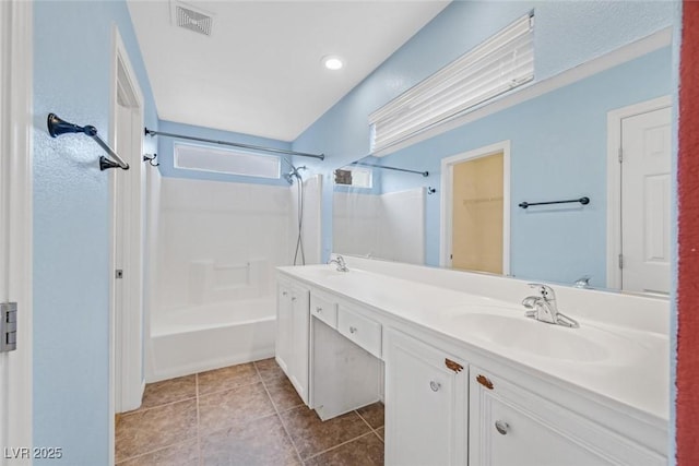 bathroom featuring tile patterned flooring, vanity, and shower / washtub combination