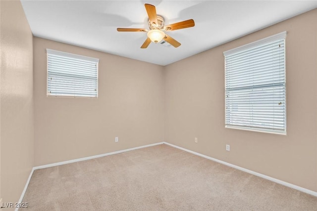 spare room featuring light carpet and ceiling fan