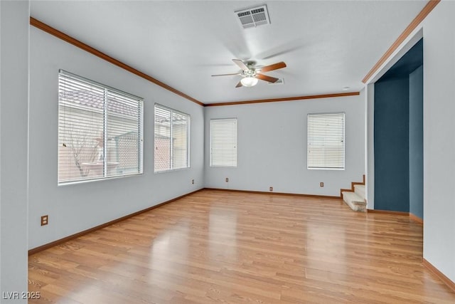 empty room with crown molding, ceiling fan, and light hardwood / wood-style floors