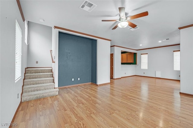 unfurnished living room with crown molding, light hardwood / wood-style flooring, and ceiling fan