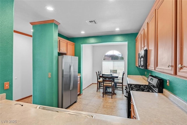 kitchen with appliances with stainless steel finishes and light tile patterned floors