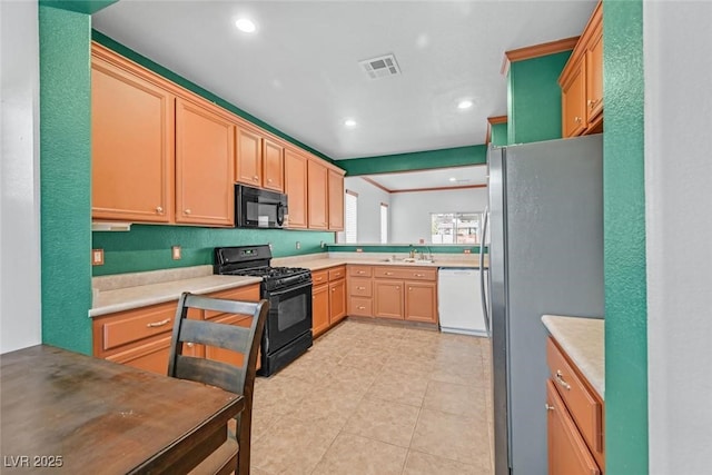 kitchen with light tile patterned flooring, sink, and black appliances